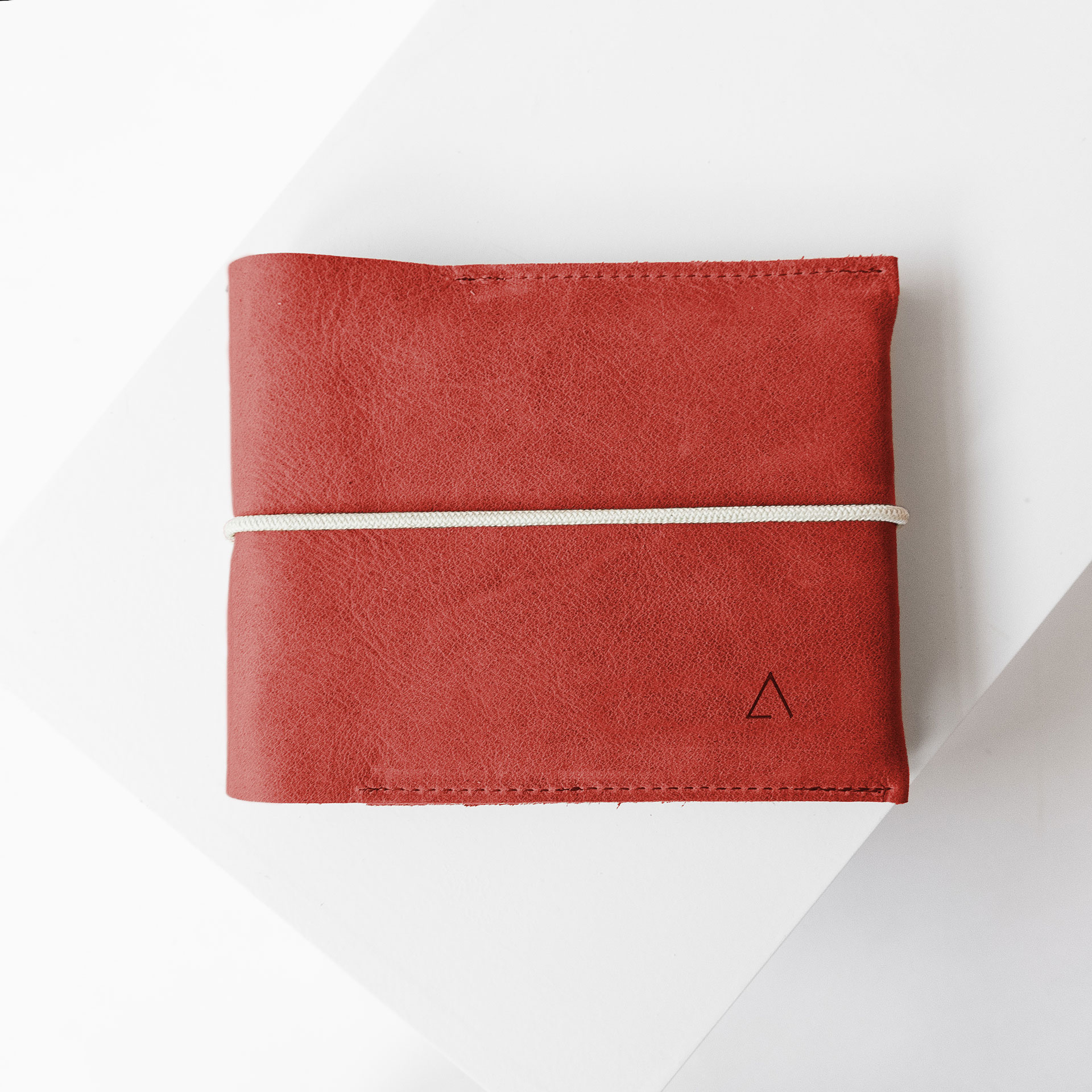 Familienreisepasshülle EVE aus nachhaltigem Naturleder in Rot mit cremefarbenem Verschlussband und dezenter Logoprägung