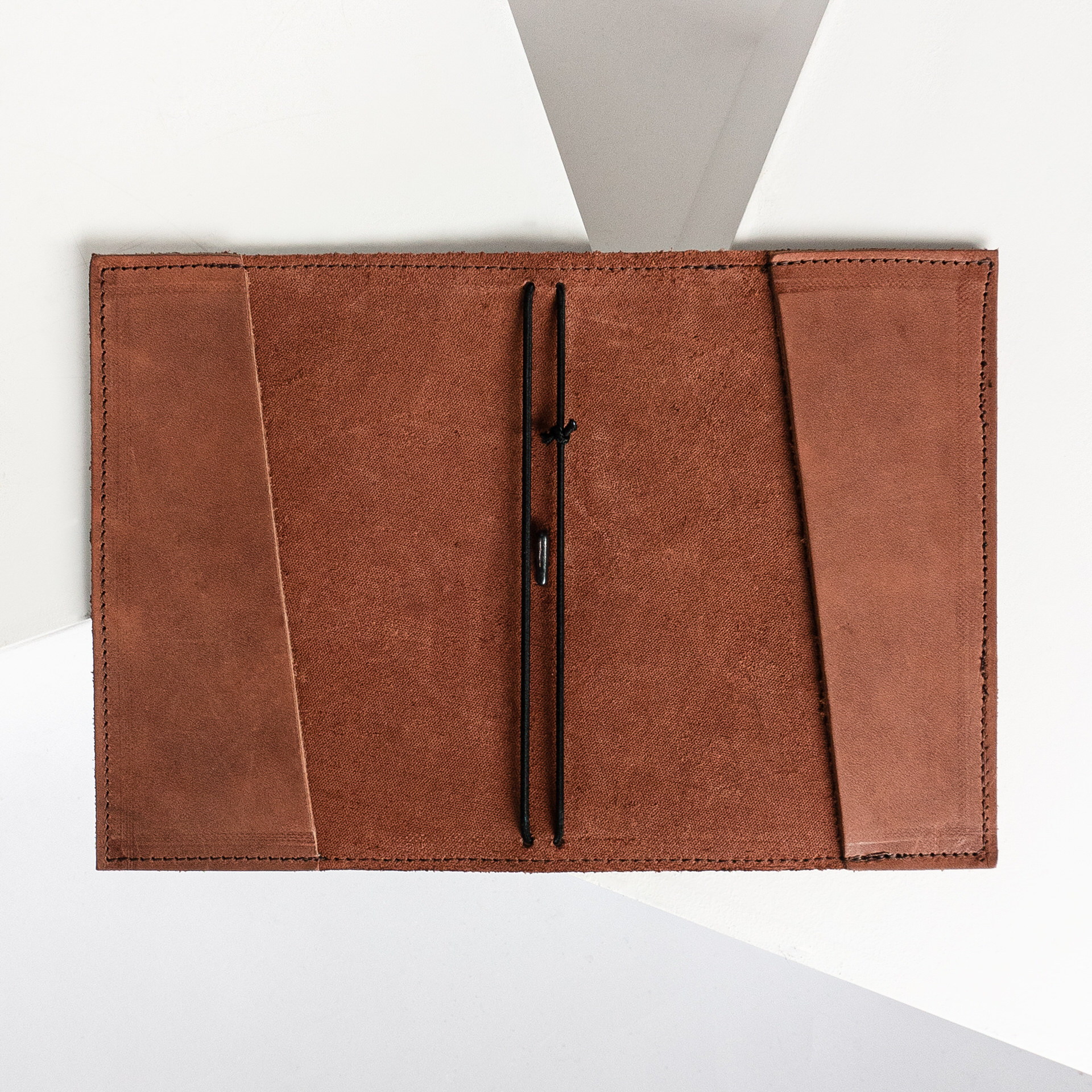 Notizbuchhülle NOA A6 in der Farbe Dunkelbraun liegt geöffnet auf dem Tisch.