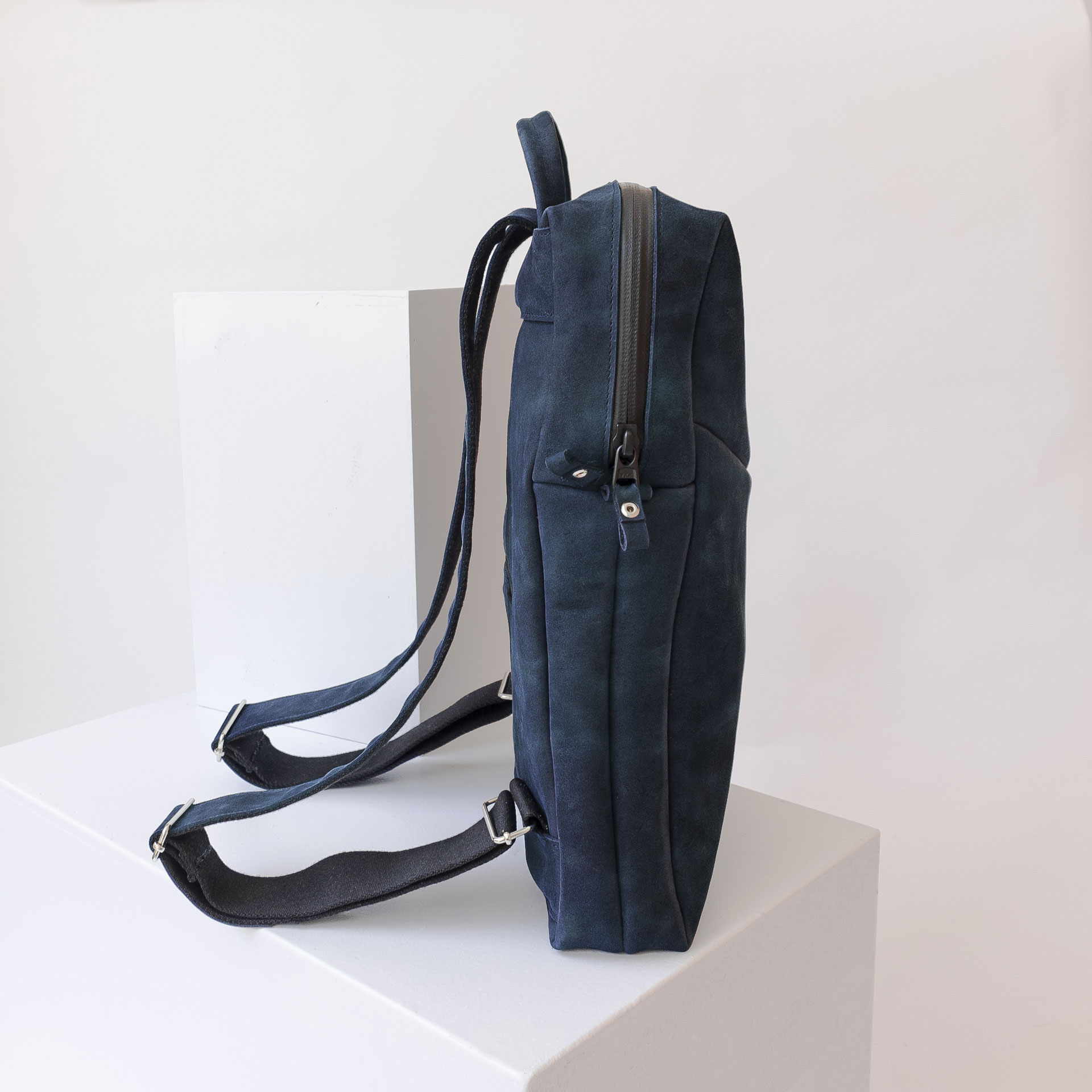 Seitenansicht des Rucksacks NEO SMALL aus Naturleder in Dunkelblau