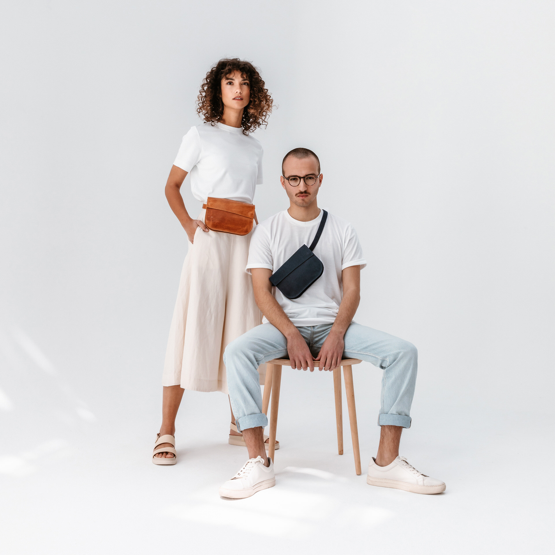 Models tragen Crossbodybag Tea in dunkelblau und cognac geölt aus nachhaltigem Naturleder