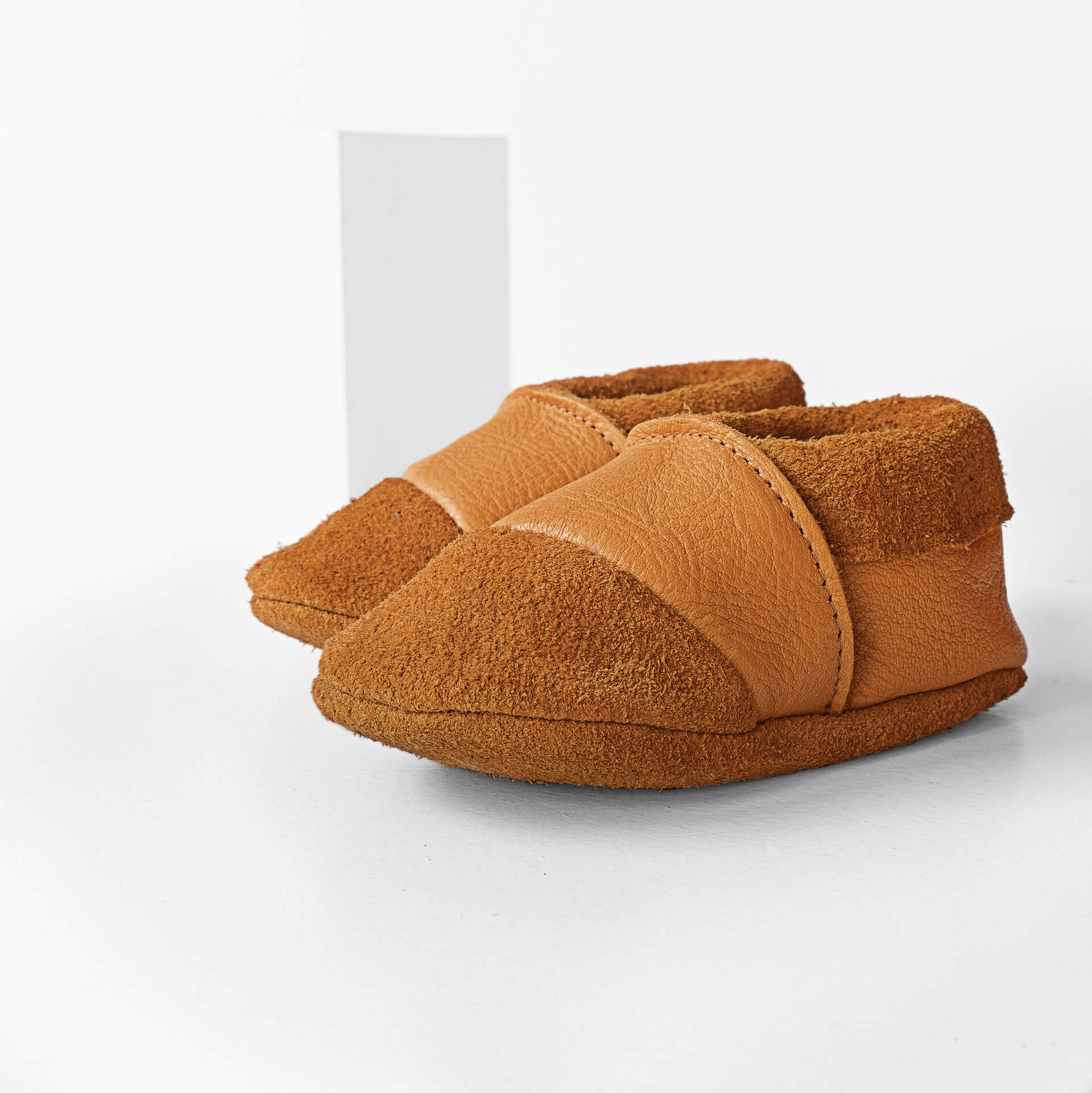 Seitliche Vorderansicht der Lauflernschuhe MOQ aus nachhaltigem Naturleder in Cognac