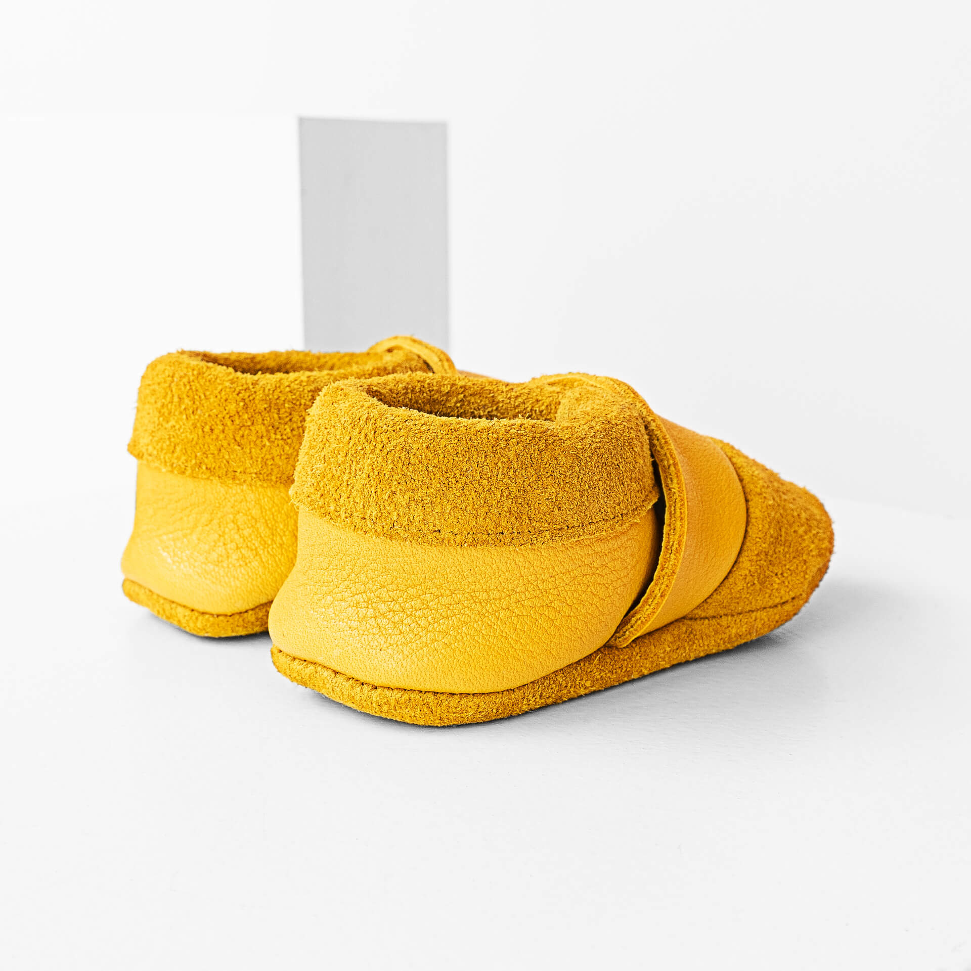 Seitliche Rückansicht der Lauflernschuhe MOQ aus nachhaltigem Naturleder in Curry